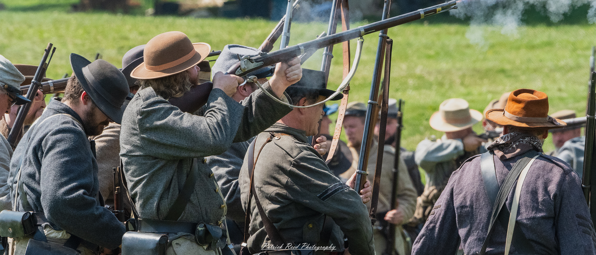 A Confederate soldier firing a rifle, his expression intense and focused as he aims down the sights. Dressed in a gray uniform, the soldier embodies the urgency and determination of battle, with smoke and the sounds of conflict surrounding him, capturing the chaos of the moment.